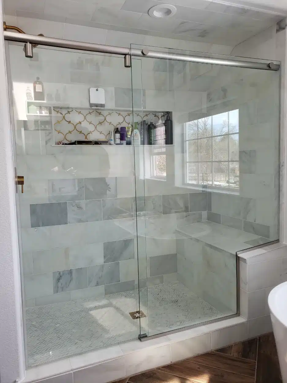 Frameless glass shower enclosure